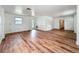 Open living room boasts wood floors, white walls, a back door and views into other areas of the home at 3019 Page Ave, Orlando, FL 32806