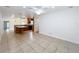 Open floor plan includes tile flooring, view of the kitchen with a breakfast bar, and white walls at 3019 Page Ave, Orlando, FL 32806