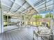 Relaxing screened-in patio featuring a ceiling fan, seating, and views of the backyard at 3019 Page Ave, Orlando, FL 32806