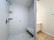 Walk-in shower features white tiles, a built-in seat, and a shower head for a modern design at 3019 Page Ave, Orlando, FL 32806