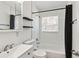 Bathroom with shower and tub combo, black shelving, and black shower curtain at 315 Tulane Dr, Altamonte Springs, FL 32714