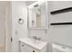 Bright bathroom with a large mirror cabinet, black shelving and updated vanity sink at 315 Tulane Dr, Altamonte Springs, FL 32714
