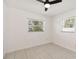 Bedroom featuring tile flooring, two windows with white blinds and a ceiling fan at 315 Tulane Dr, Altamonte Springs, FL 32714