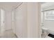 Hallway featuring tiled flooring, neutral walls, a closet with bi-fold doors, and a bathroom at 315 Tulane Dr, Altamonte Springs, FL 32714