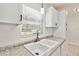 Close up of kitchen sink featuring white cabinetry, countertops, stainless faucet and a window with blinds at 315 Tulane Dr, Altamonte Springs, FL 32714