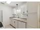 Kitchen featuring white cabinets, countertops, stainless appliances, and a double basin sink at 315 Tulane Dr, Altamonte Springs, FL 32714