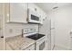 Close up of kitchen featuring white microwave, oven, and countertops, paired with modern hardware at 315 Tulane Dr, Altamonte Springs, FL 32714