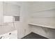 Simple laundry area with open shelves and window for a practical utility space at 315 Tulane Dr, Altamonte Springs, FL 32714