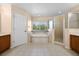 Bright bathroom with double vanity, soaking tub, glass shower, and window at 346 Willet Ave, Apopka, FL 32703