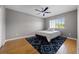 Well lit bedroom featuring hardwood floors, ceiling fan, area rug, and window at 346 Willet Ave, Apopka, FL 32703