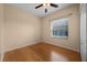 Cozy bedroom featuring a window, hardwood floors, and a ceiling fan at 346 Willet Ave, Apopka, FL 32703