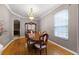 Formal dining room features chandelier, wood table and chairs, and a china cabinet at 346 Willet Ave, Apopka, FL 32703