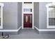 Close-up of the front door with decorative glass and sidelight, framed by the home's architectural details at 346 Willet Ave, Apopka, FL 32703
