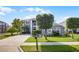Two-story home showing its landscaped front yard, gray stucco, and striking entryway pillars on a sunny day at 346 Willet Ave, Apopka, FL 32703