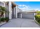 View of the home's front exterior featuring a large garage, stucco walls, and manicured landscaping at 346 Willet Ave, Apopka, FL 32703
