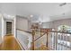 Second floor hallway with hardwood floors and access to multiple rooms at 346 Willet Ave, Apopka, FL 32703