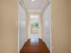 Hallway featuring hardwood floors, closet doors, and doorway to main bathroom at 346 Willet Ave, Apopka, FL 32703