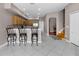 Open kitchen layout with bar stool seating, stainless steel appliances, and tile flooring throughout at 346 Willet Ave, Apopka, FL 32703