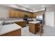 Kitchen with island, stainless steel appliances, bar stool seating and tile flooring at 346 Willet Ave, Apopka, FL 32703