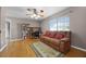Comfortable living room features a ceiling fan, window, and wood floors at 346 Willet Ave, Apopka, FL 32703