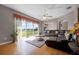Cozy living room with large windows, hardwood floors, and comfortable seating at 346 Willet Ave, Apopka, FL 32703