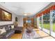 Spacious living room with wood floors, plush leather sofa, and sliding glass doors at 346 Willet Ave, Apopka, FL 32703