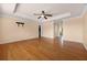 Spacious main bedroom featuring wood floors, tray ceilings and fan with access to the main bathroom at 346 Willet Ave, Apopka, FL 32703