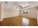 A naturally lit main bedroom features hardwood floors, tray ceilings and a fan at 346 Willet Ave, Apopka, FL 32703