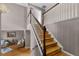 Hardwood staircase with white banister leads to the upper level of the home at 346 Willet Ave, Apopka, FL 32703