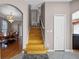 Staircase leading to upper level with hardwood steps and an elegant chandelier in the adjacent dining room at 346 Willet Ave, Apopka, FL 32703