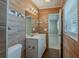 Nicely updated bathroom showcasing wood-look tile, a vanity, and bright lighting at 3718 Mitchell Rd, Orlando, FL 32808