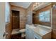 Updated bathroom featuring wood-look tile walls, a shower, and a modern vanity at 3718 Mitchell Rd, Orlando, FL 32808