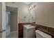 Modern bathroom with new fixtures and tiled wall feature plus adjacent open doorway at 3718 Mitchell Rd, Orlando, FL 32808