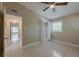 Bedroom featuring tile flooring, ceiling fan, closet and hallway access at 3718 Mitchell Rd, Orlando, FL 32808