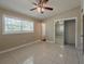 Bedroom boasts tile floors, a ceiling fan, and a closet with mirrored sliding doors at 3718 Mitchell Rd, Orlando, FL 32808