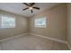 Bright bedroom features two windows, a ceiling fan, and tile flooring at 3718 Mitchell Rd, Orlando, FL 32808