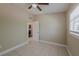 This bedroom has a ceiling fan and a window; door leads to another room at 3718 Mitchell Rd, Orlando, FL 32808