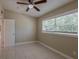 Cozy bedroom with tile flooring, ceiling fan, and natural light from the window at 3718 Mitchell Rd, Orlando, FL 32808