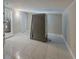 Versatile bonus room with tile flooring and views to the utility room at 3718 Mitchell Rd, Orlando, FL 32808