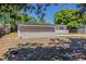 View of the house's back exterior, blending brick and siding, framed by a wooded perimeter at 3718 Mitchell Rd, Orlando, FL 32808