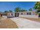 One-story home featuring white shutters, complemented by a well-maintained lawn and a long driveway at 3718 Mitchell Rd, Orlando, FL 32808