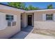Entrance view showcasing neutral siding, clean lines, an AC unit, and a decorative front door at 3718 Mitchell Rd, Orlando, FL 32808