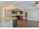 Kitchen with granite island, modern appliances and wood flooring at 3718 Mitchell Rd, Orlando, FL 32808