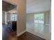 Open concept living room with light tile flooring adjacent to kitchen at 3718 Mitchell Rd, Orlando, FL 32808