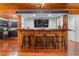 Basement bar with wood countertop, seating for four, and views into the kitchen area at 409 San Sebastian Prado, Altamonte Springs, FL 32714