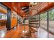 Spiral staircase in finished basement with wood paneling, hardwood floors, and large windows at 409 San Sebastian Prado, Altamonte Springs, FL 32714