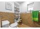 Rustic bathroom features a toilet, window, and decorative shelving at 409 San Sebastian Prado, Altamonte Springs, FL 32714