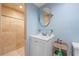 Bright bathroom with a walk-in shower and modern vanity with a round mirror at 409 San Sebastian Prado, Altamonte Springs, FL 32714