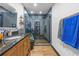 Modern bathroom with dark vanity, glass shower, and decorative blue and grey towels at 409 San Sebastian Prado, Altamonte Springs, FL 32714