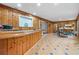 Bonus room featuring wood paneling, tile floors, and custom wood bar at 409 San Sebastian Prado, Altamonte Springs, FL 32714